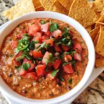 This simple, no-cook taco dip comes together quickly and is perfect for any occasion. With creamy layers of flavorful ingredients and a customizable base, this taco dip is sure to please any crowd!